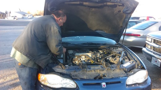 Arthur Shaffer Sr. inspects a belt for a customer at his garage, which has turned into a family business of sorts over the years.